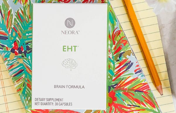 Lifestyle shot of Neora's EHT laid on top of a notepad.